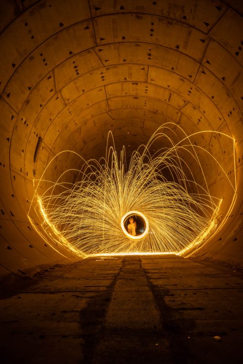 Free Captivating steel wool light painting in a subway tunnel, sparks creating a vortex effect. Stock Photo