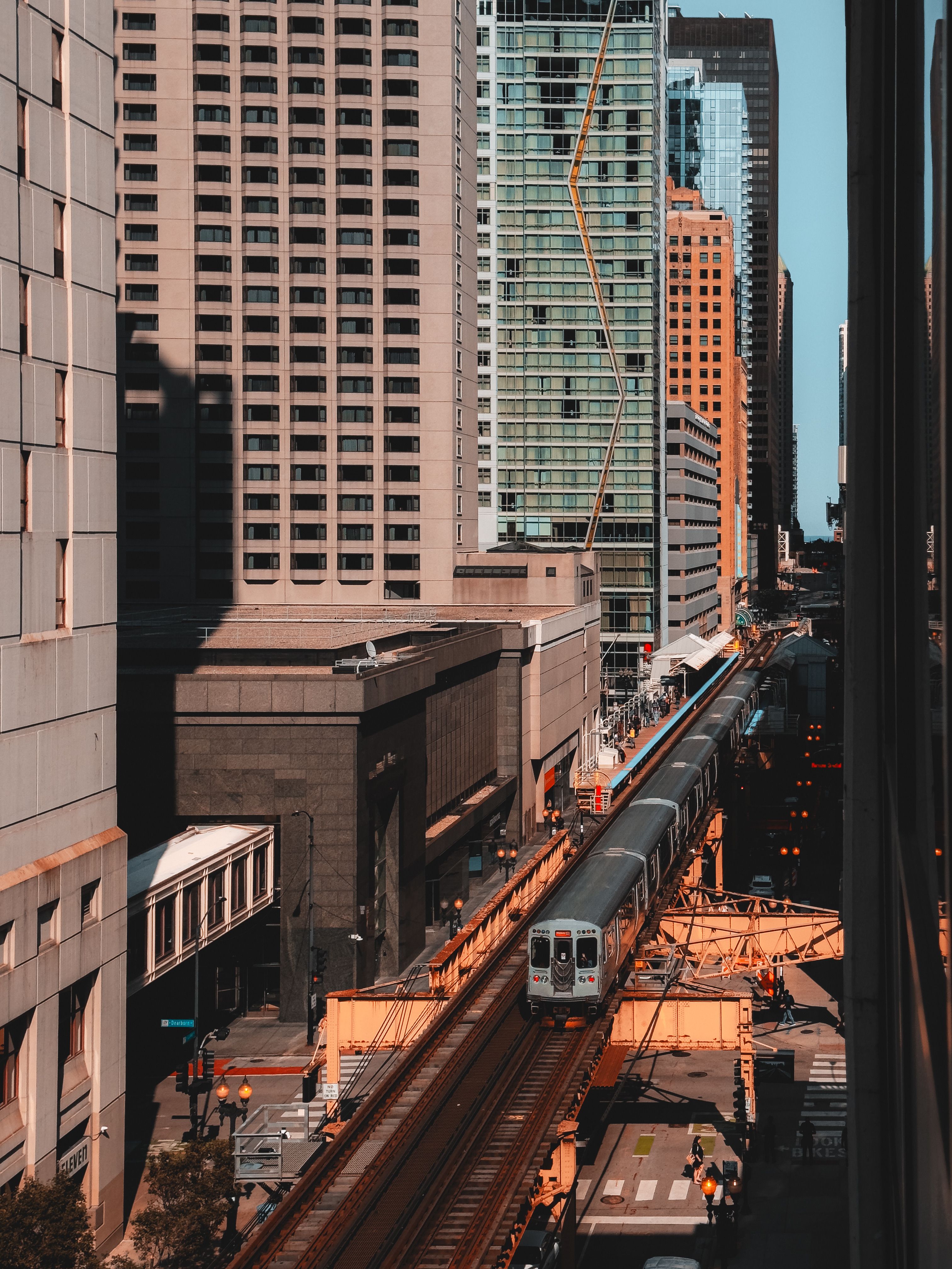 A train traveling through a city with tall buildings · Free Stock Photo