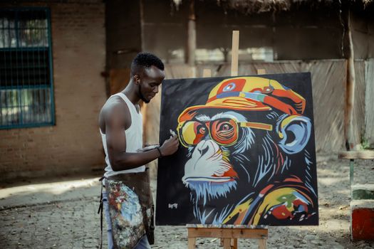 A street artist paints a vibrant chimpanzee artwork outdoors, showcasing urban creativity.