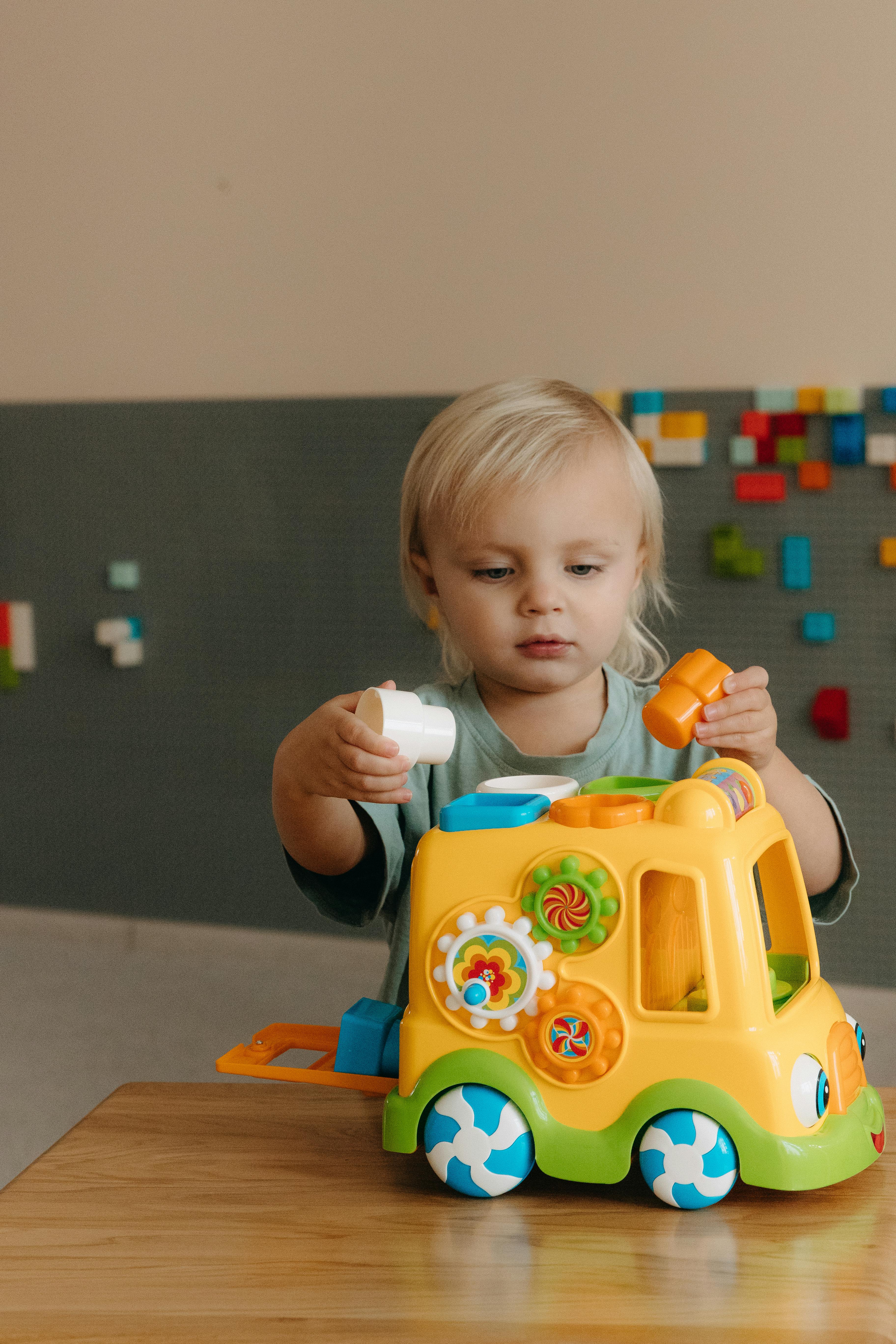 a young child playing with a toy truck