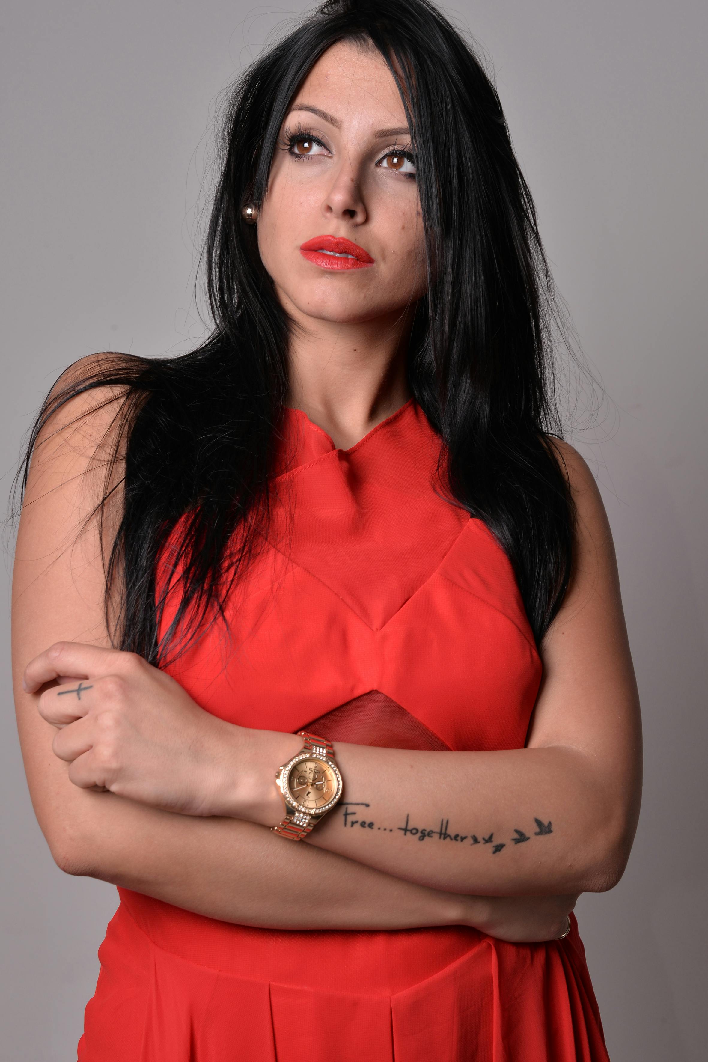 Portrait of a young woman in a red dress, showcasing elegance and modern fashion style.