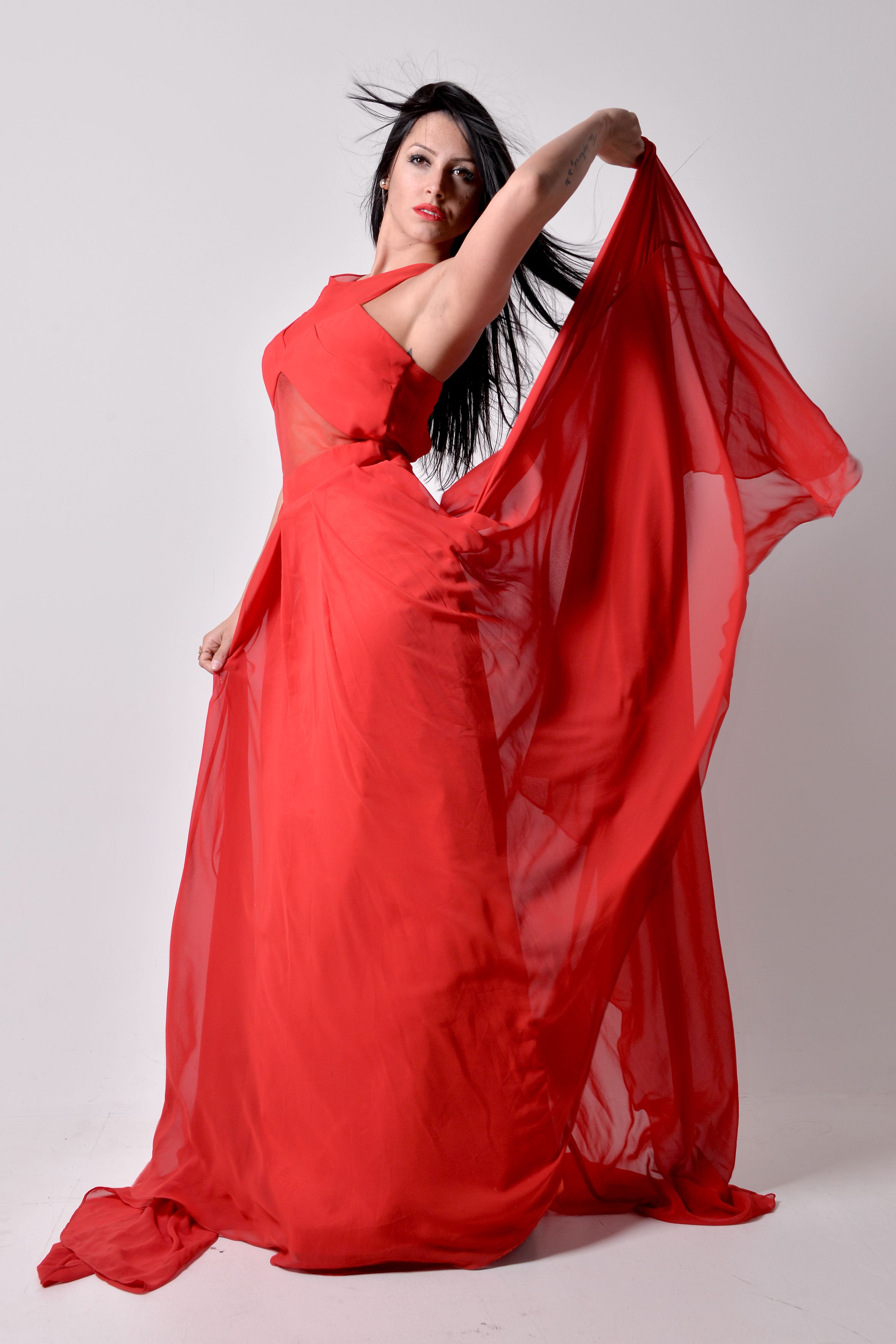 A woman in a red dress posing for a photo · Free Stock Photo