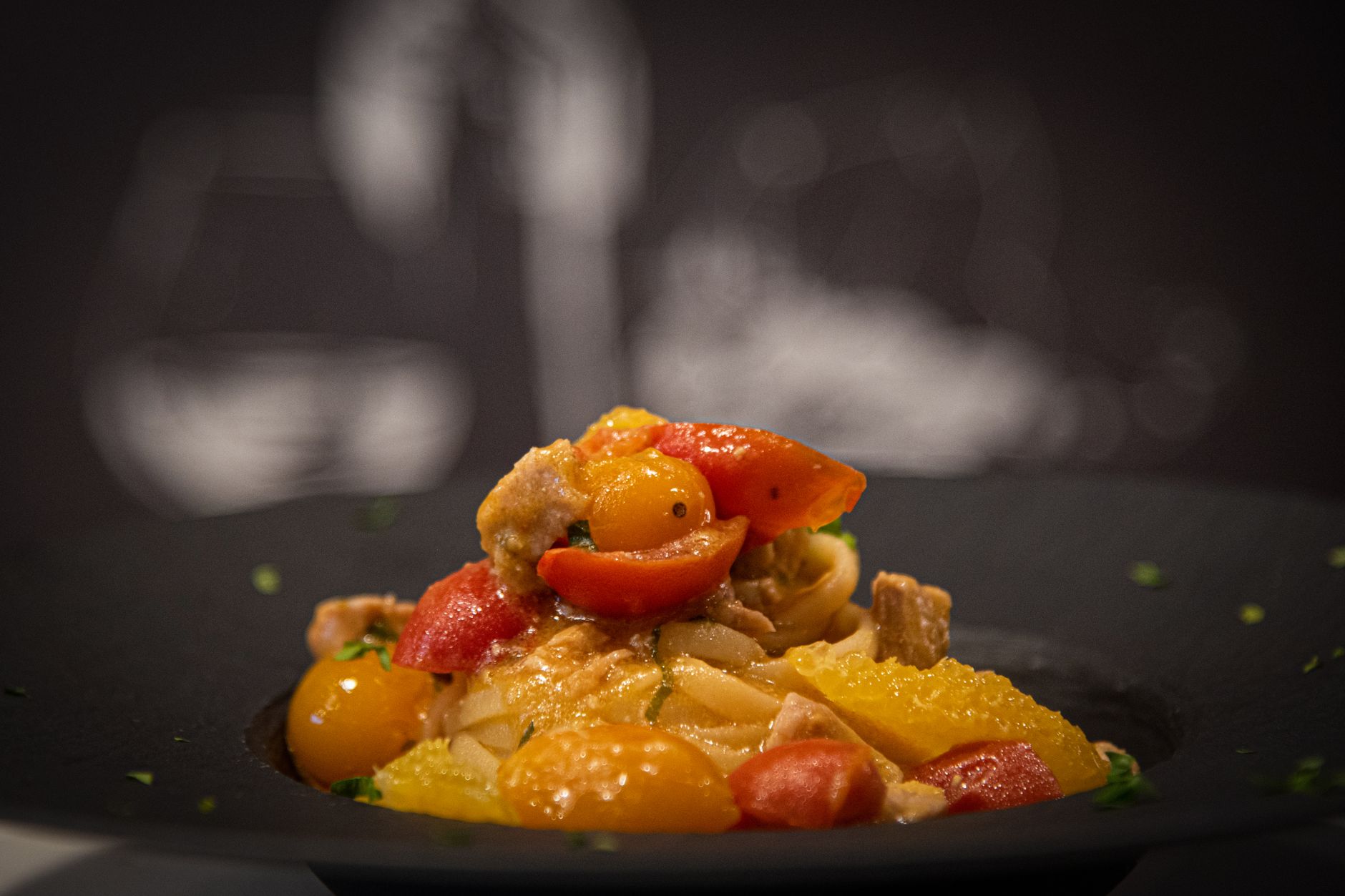 Yellow tomato sauce with fresh basil on pasta