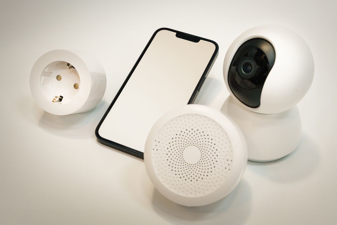 Smart home devices including a security camera and speaker on a table
