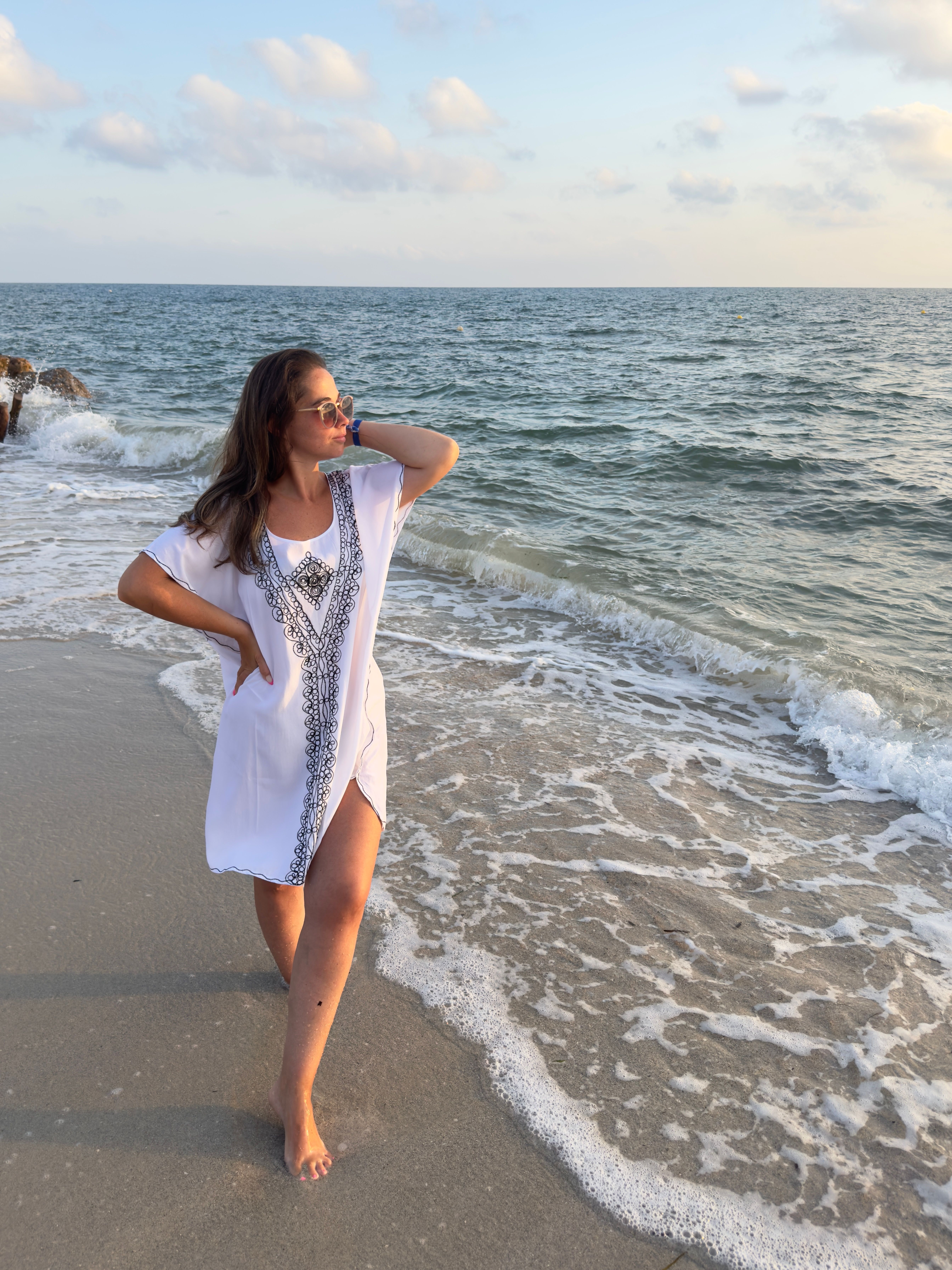 A woman in a white dress standing on the beach · Free Stock Photo
