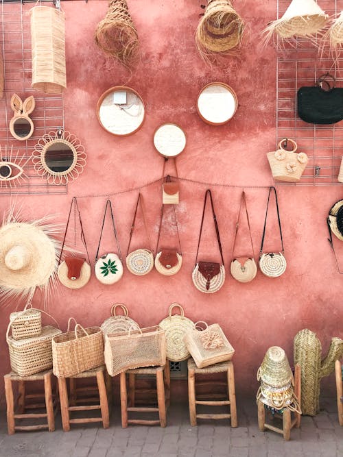Free Photo Of Wicker Bags And Straw Hats On A Pink Wall Stock Photo