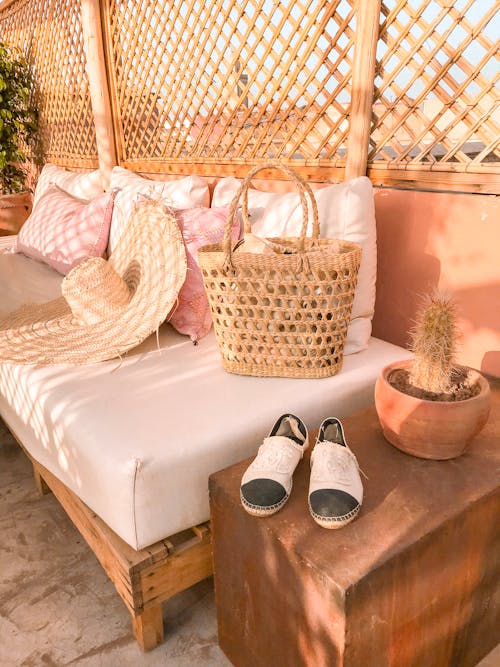 Free Photo Of Wicker Bag and Straw Hat On Top Of The Sofa Stock Photo