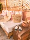 Photo Of Wicker Bag and Straw Hat On Top Of The Sofa