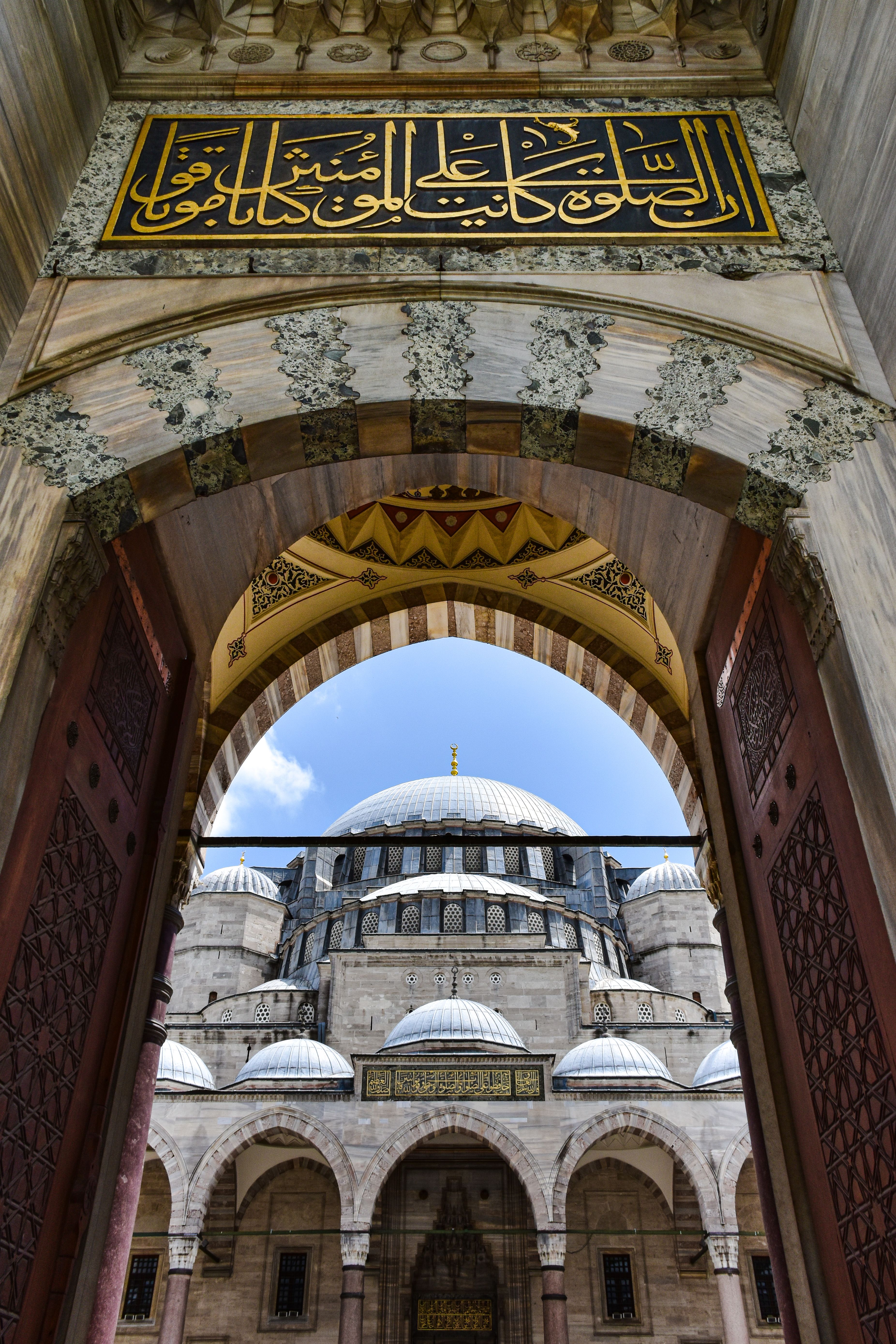 The entrance to a mosque with arabic writing · Free Stock Photo