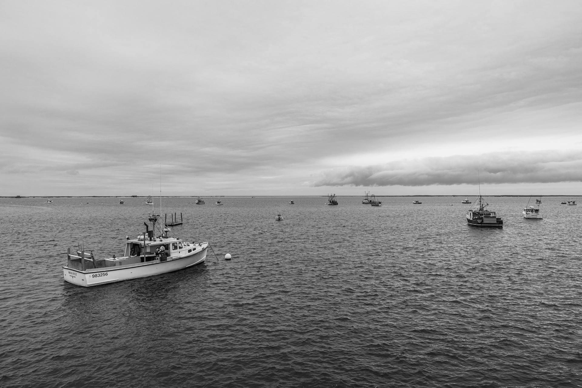 Black and white image of fishing boats in Chatham Harbor, MA, USA.