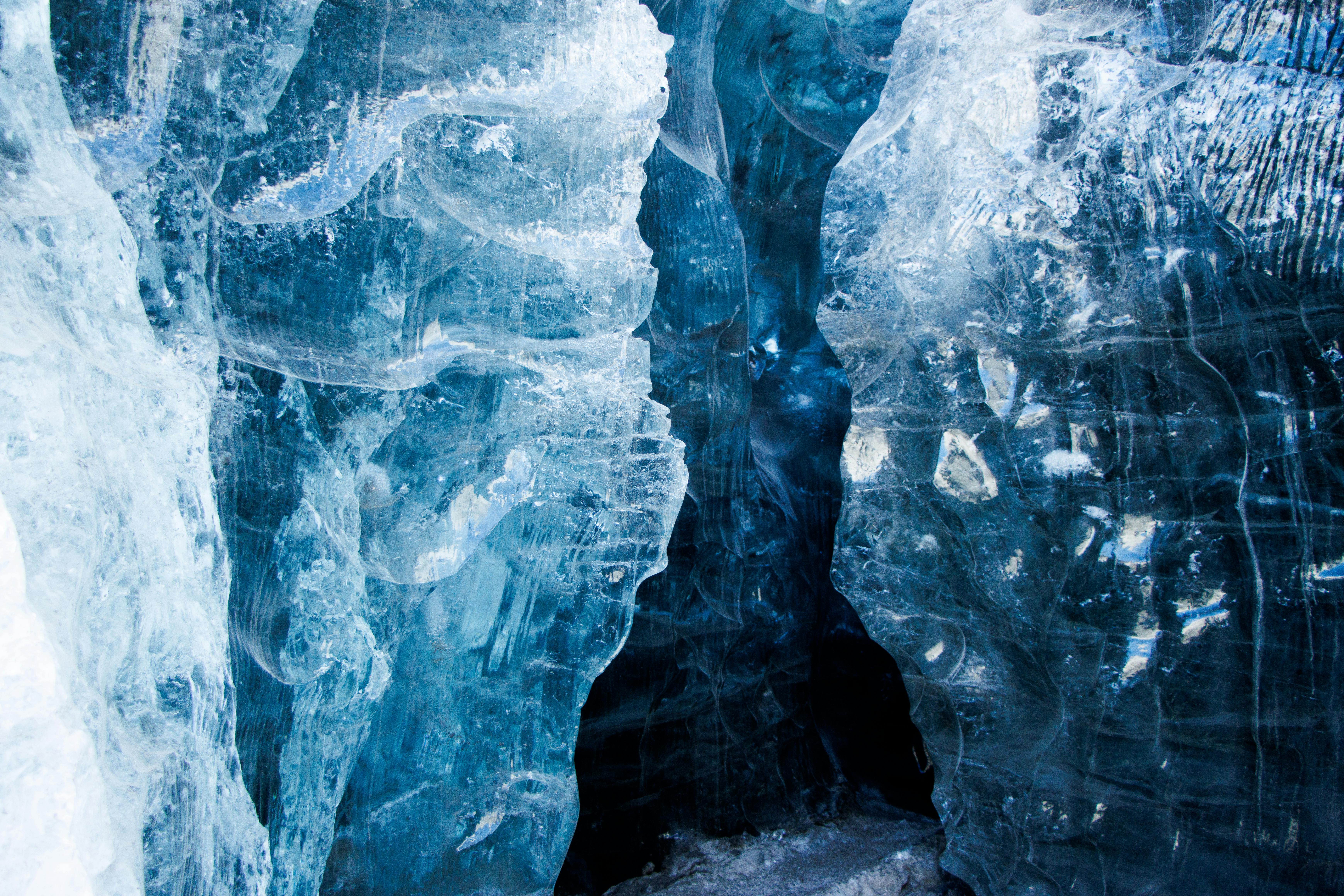 Explore the enchanting blue ice cave with stunning textures and icy formations.