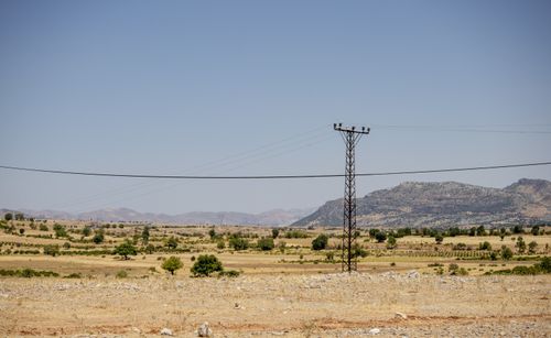 Free Summer landscape of a dry rural field with power lines in Çermik, Diyarbakır, Turkey. Stock Photo