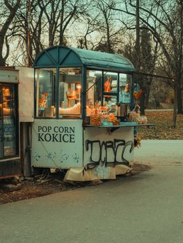 Quaint outdoor popcorn stand with urban park background, capturing vintage charm.