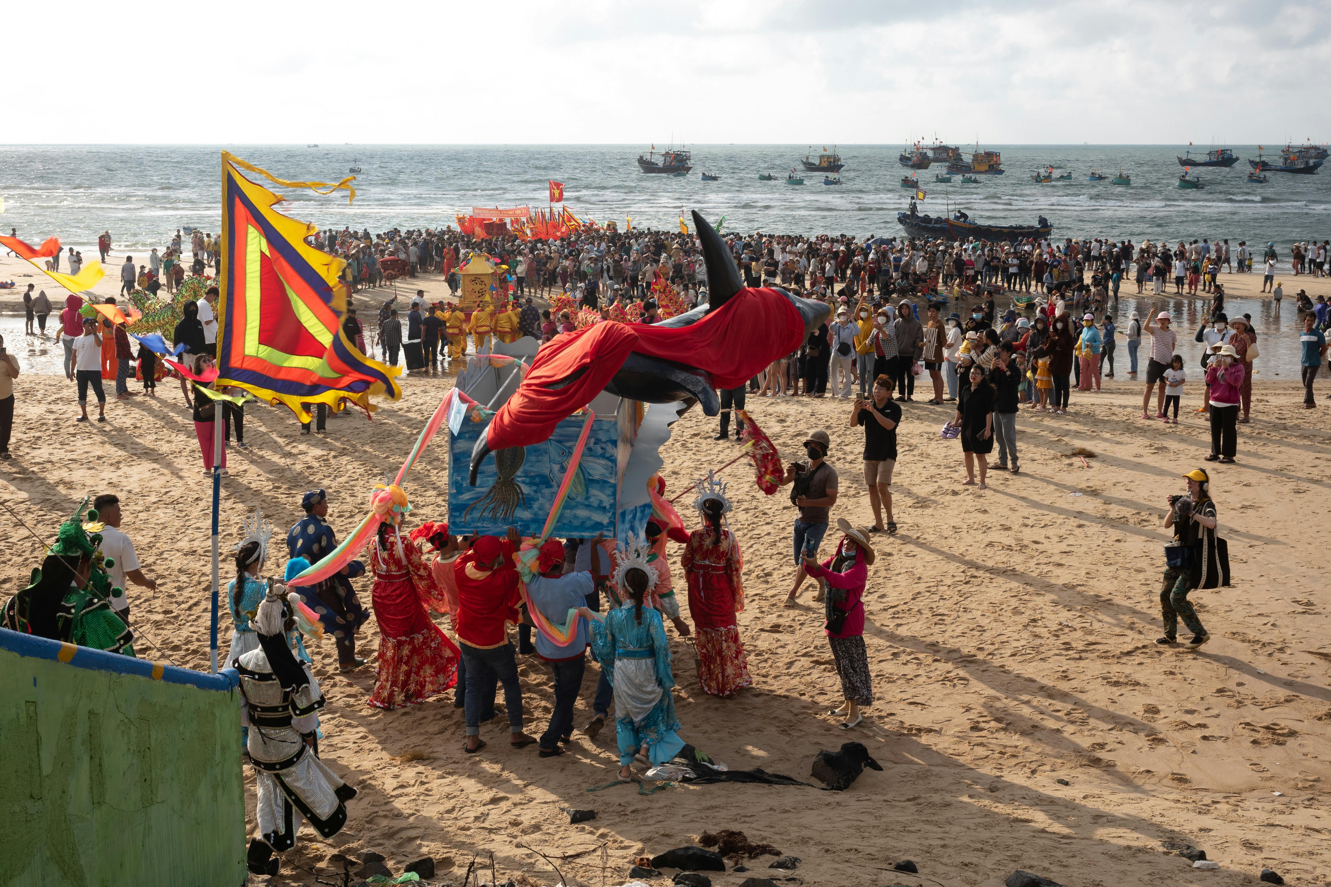 A vibrant beach festival in Vũng Tàu, Vietnam with crowds, flags, and cultural celebrations.