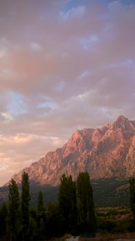Majestic mountain view in Yelatan, Türkiye, with vibrant sunset skies creating a serene landscape.