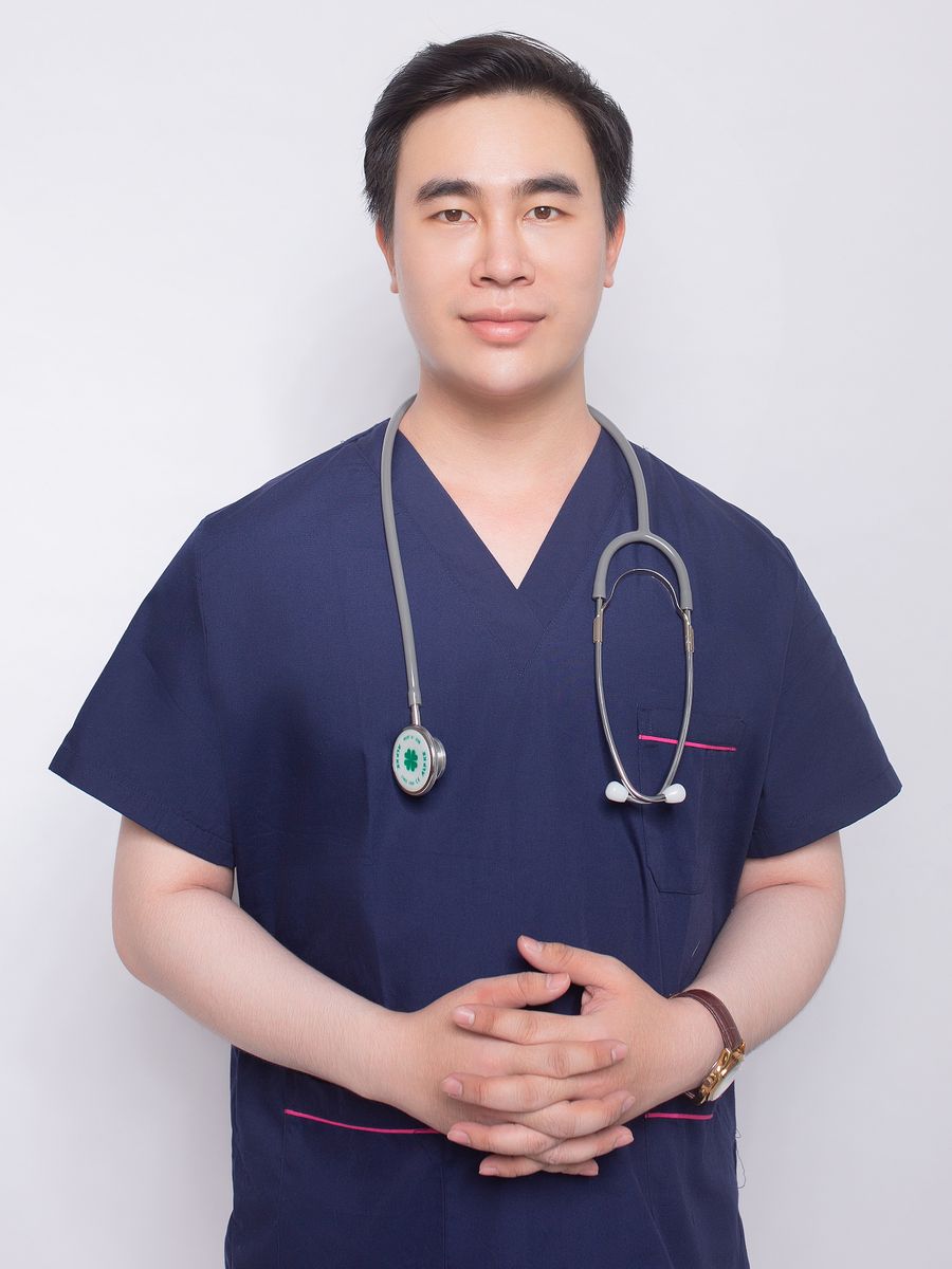 Male medical professional wearing midnight navy scrubs