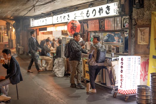 Bustling Tokyo street market at night, with people enjoying food and conversation.