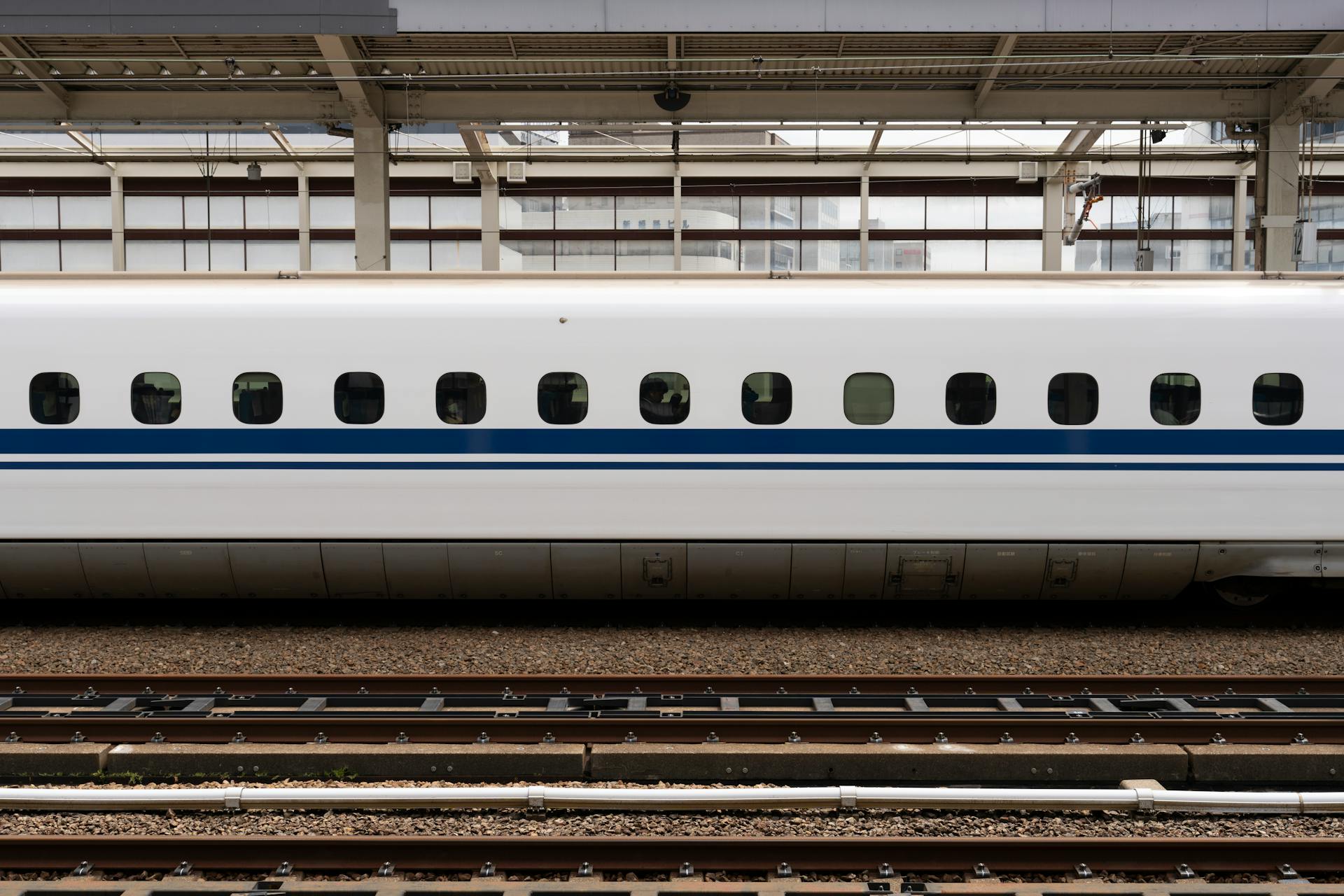 High-speed bullet train on a platform at Osaka Station, showcasing modern transportation.