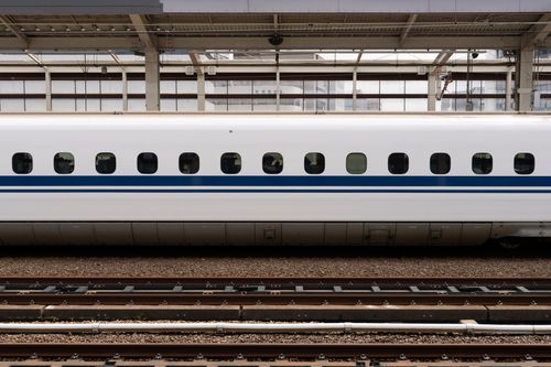 Free High-speed bullet train on a platform at Osaka Station, showcasing modern transportation. Stock Photo