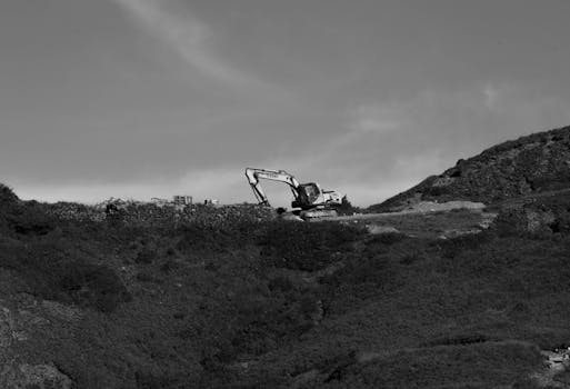 Black and white photo of an excavator on a mountain in Nantou County, Taiwan.