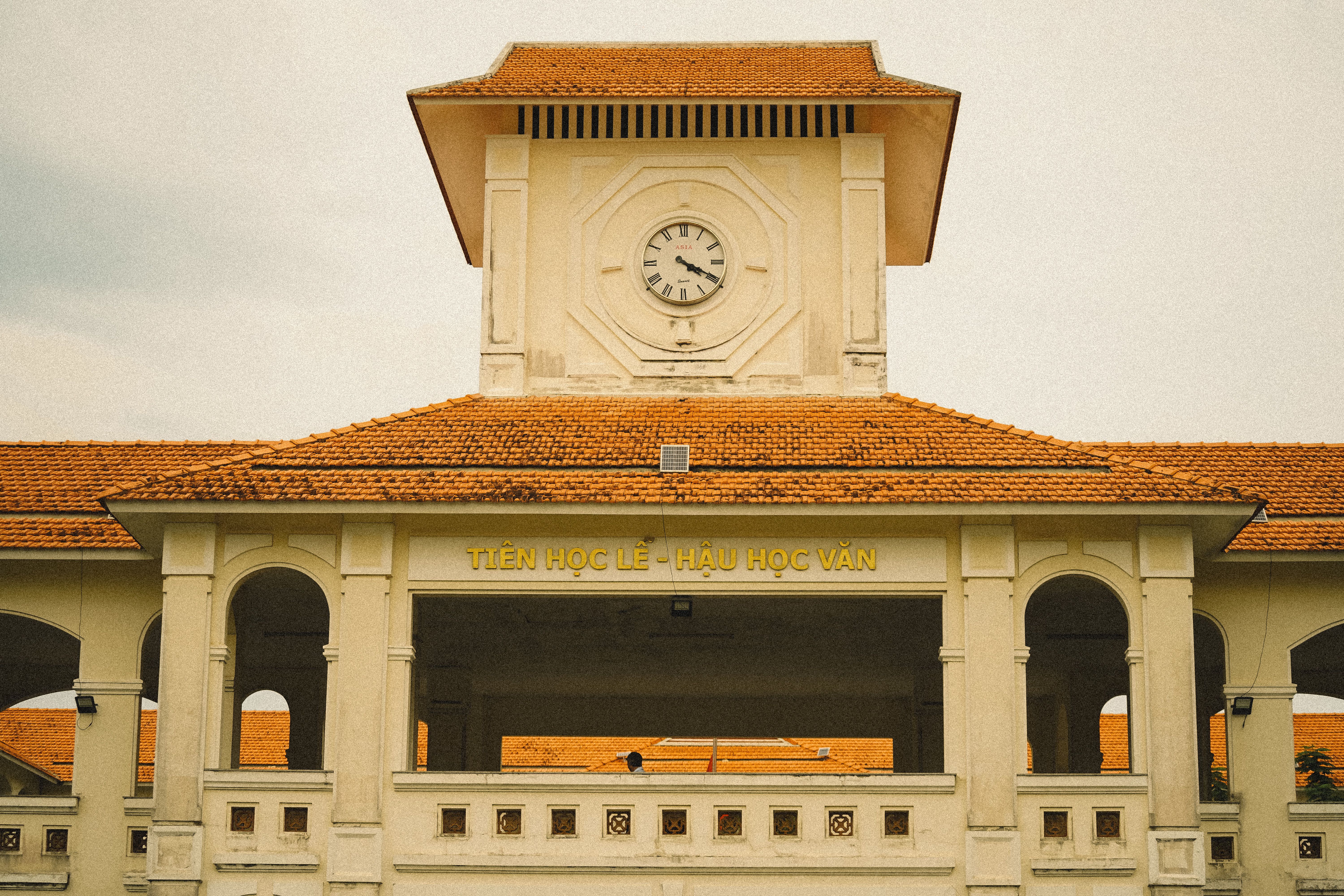 A clock tower on top of a building with a red roof · Free Stock Photo