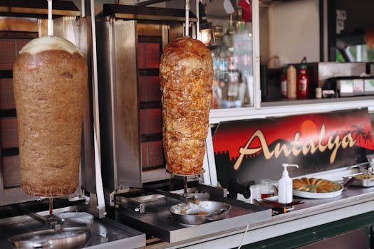 Authentic shawarma rotating on spits in a street food stall in Antalya. Perfect Turkish culinary experience.