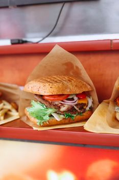 Close-up of a mouthwatering cheeseburger with fresh toppings and fries, perfect lunch.