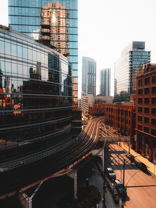 Free Dynamic cityscape featuring skyscrapers and elevated railway tracks reflecting urban modernity. Stock Photo