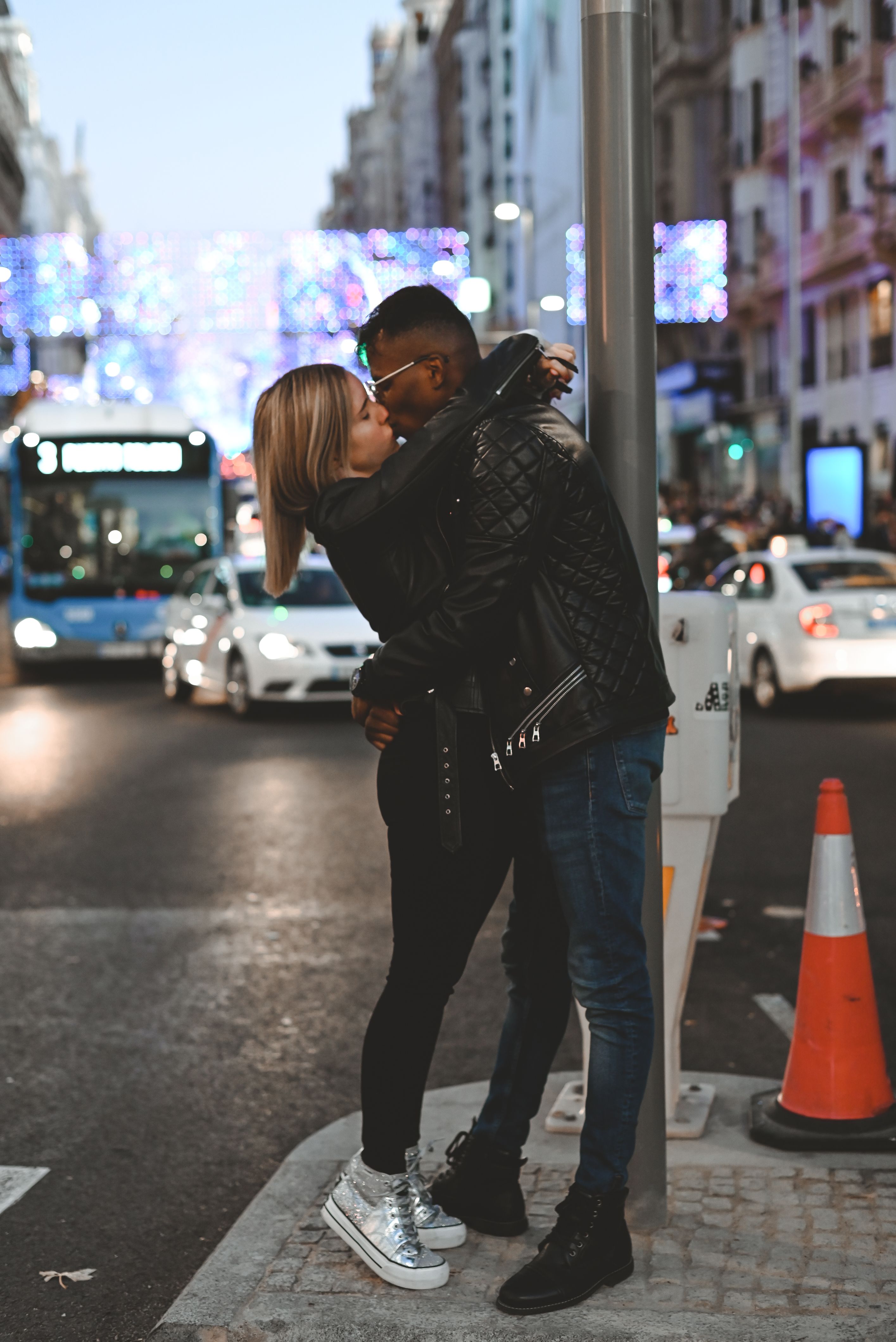 A couple kissing in the street at night · Free Stock Photo