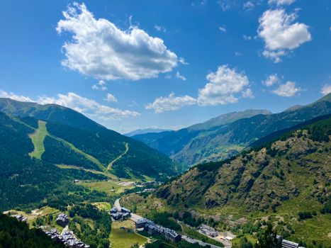 Beautiful view of Soldeu in Andorra, showcasing lush valleys and majestic mountains under a clear sky.