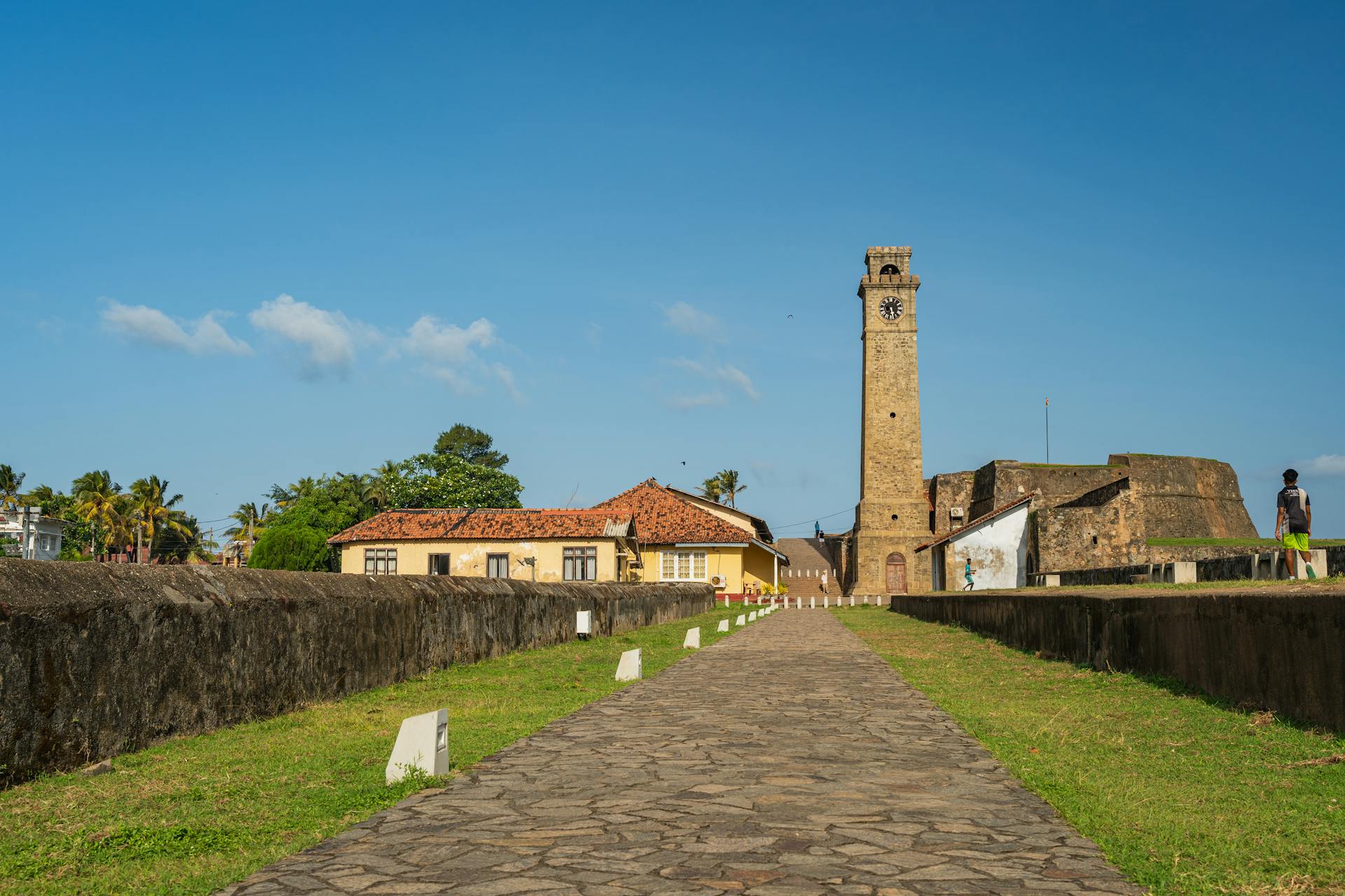 Explore the historic Galle Fort with its iconic clock tower under a clear, sunny sky.