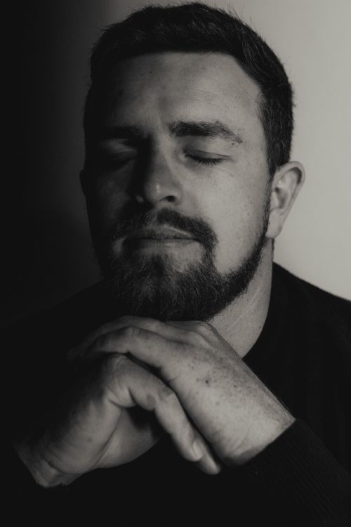 Free A thoughtful portrait of a bearded man with eyes closed, conveying introspection. Stock Photo