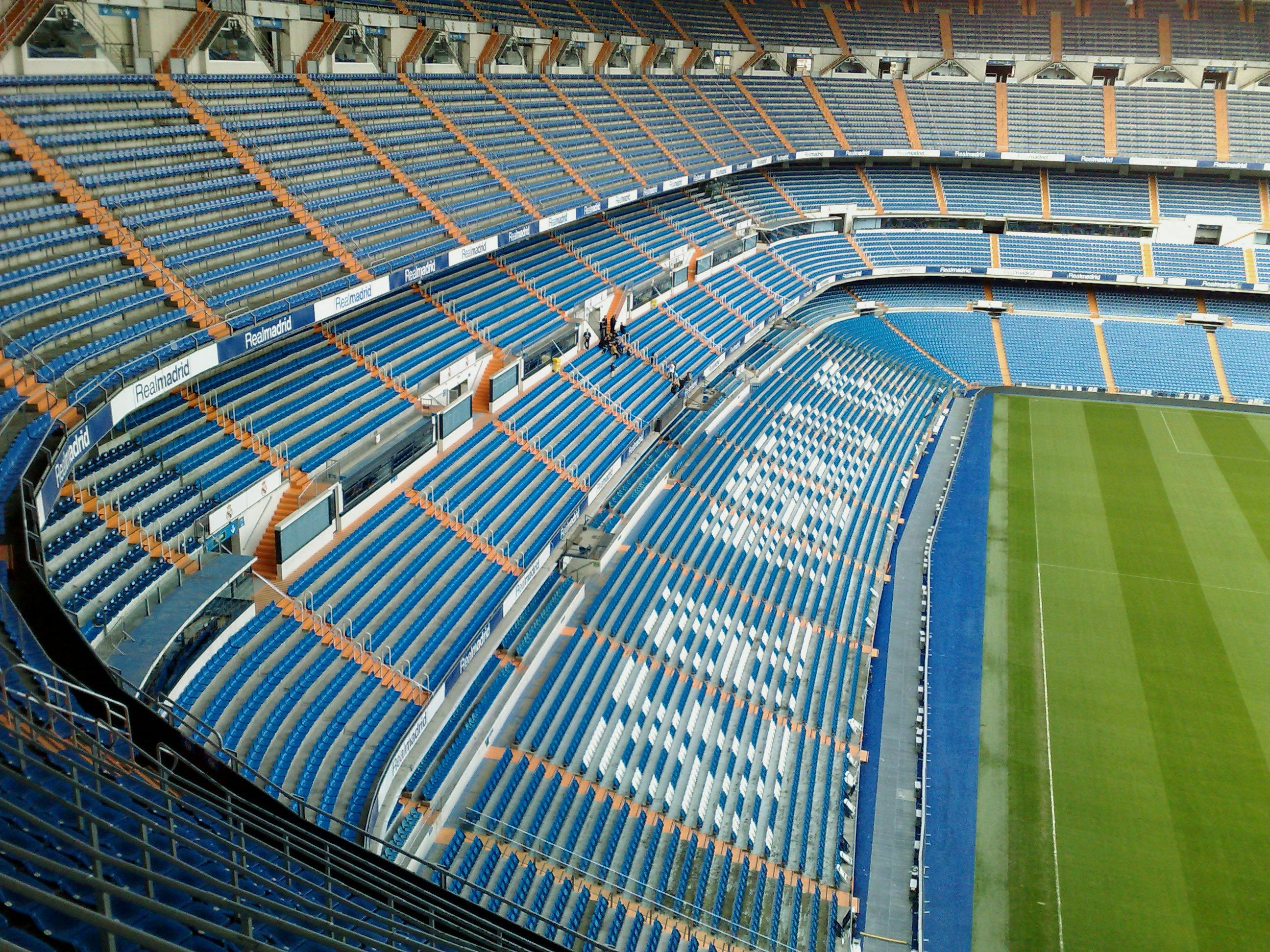 Aerial view of an empty stadium seating area in Madrid, showcasing a modern architectural design.