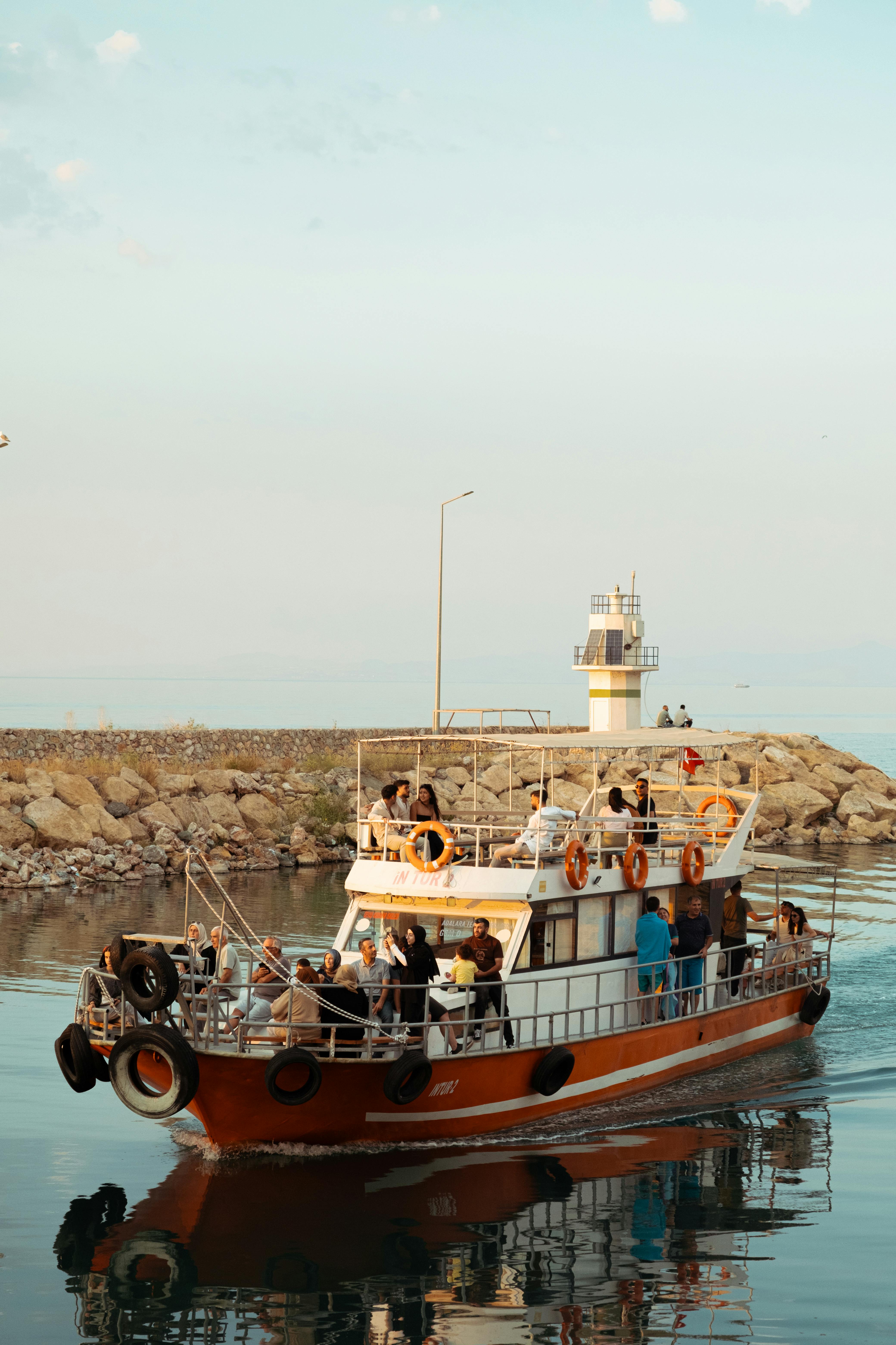 a boat is traveling through the water near a lighthouse