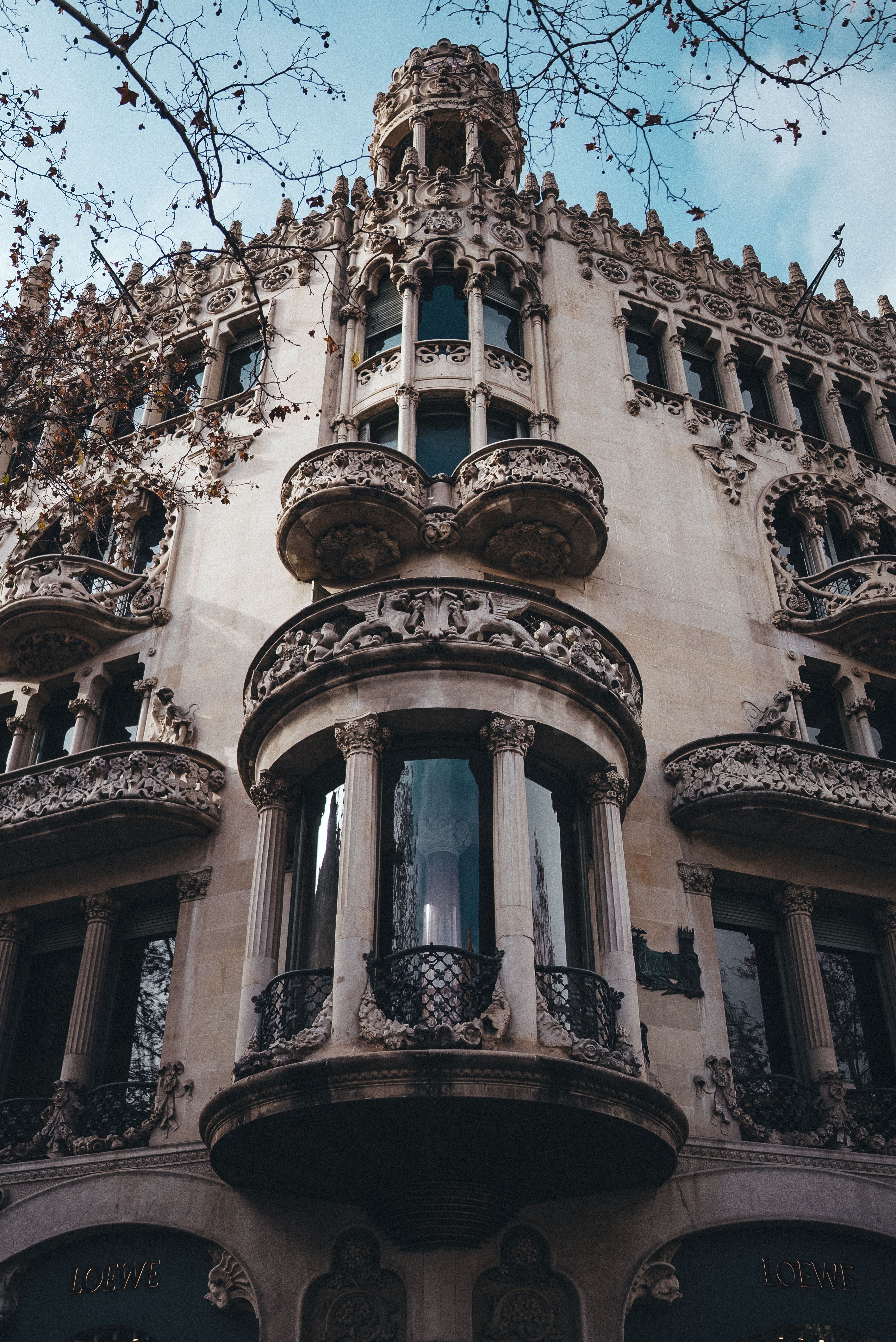 The building has ornate windows and balconies · Free Stock Photo