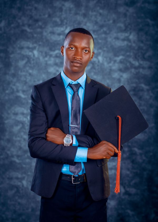 A confident young male graduate in formal attire