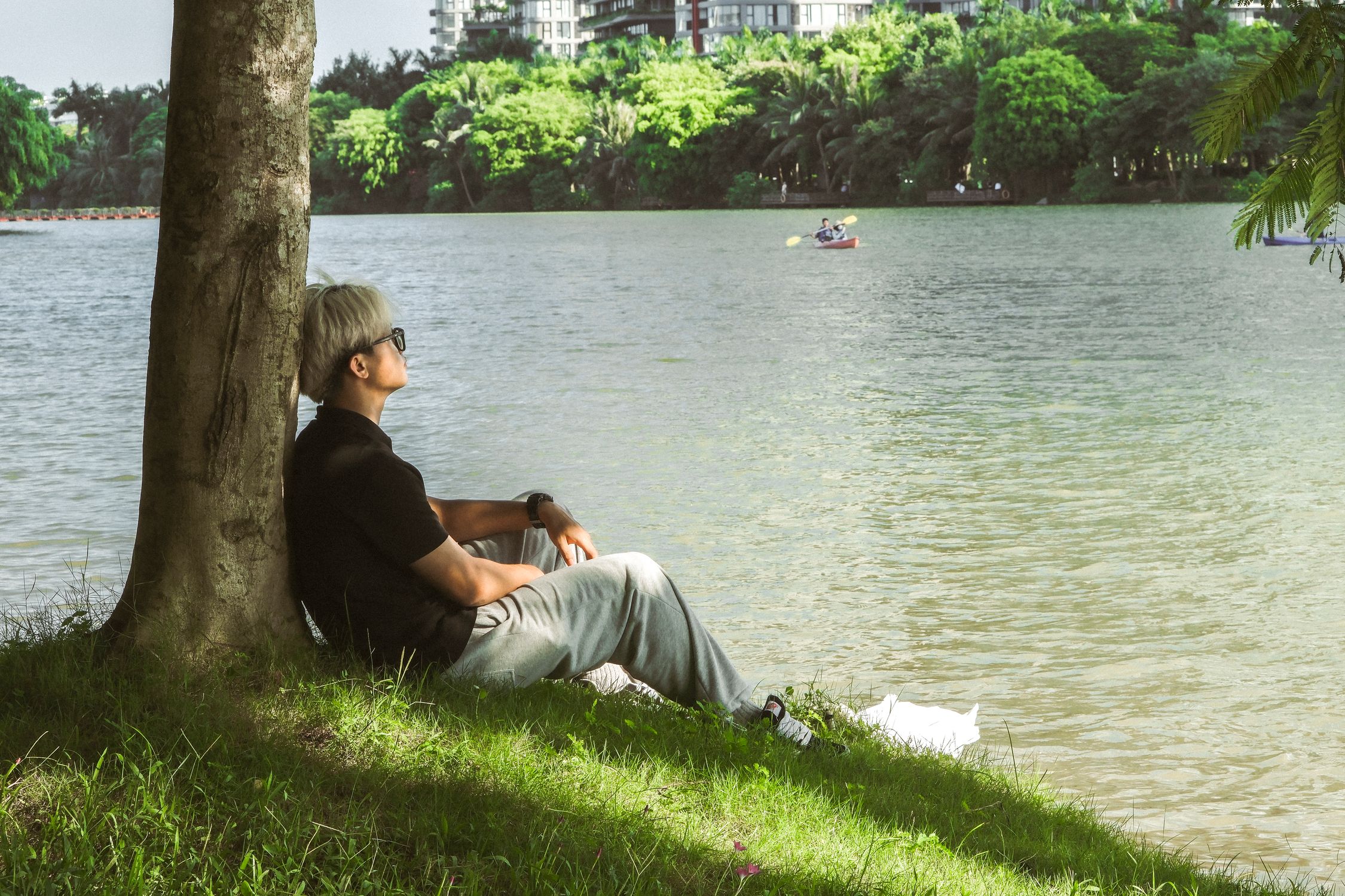A man sitting on a bench by the water · Free Stock Photo