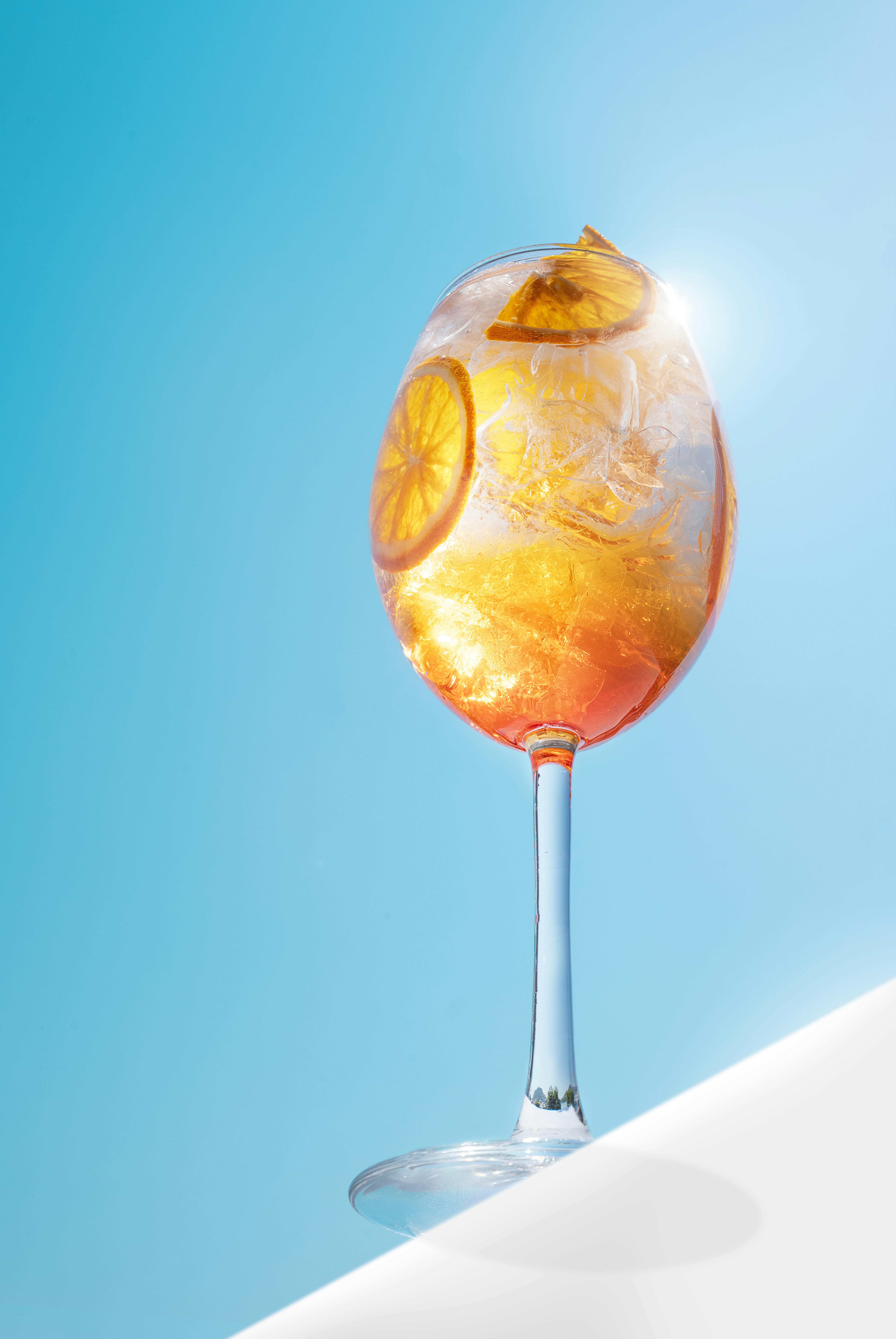 A glass of orange juice with a slice of orange