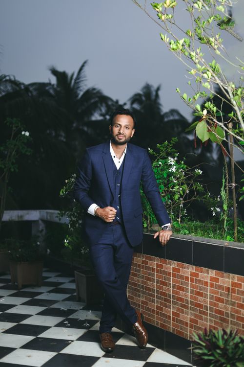 Free A man in a stylish blue suit poses outdoors, exuding confidence and elegance. Stock Photo