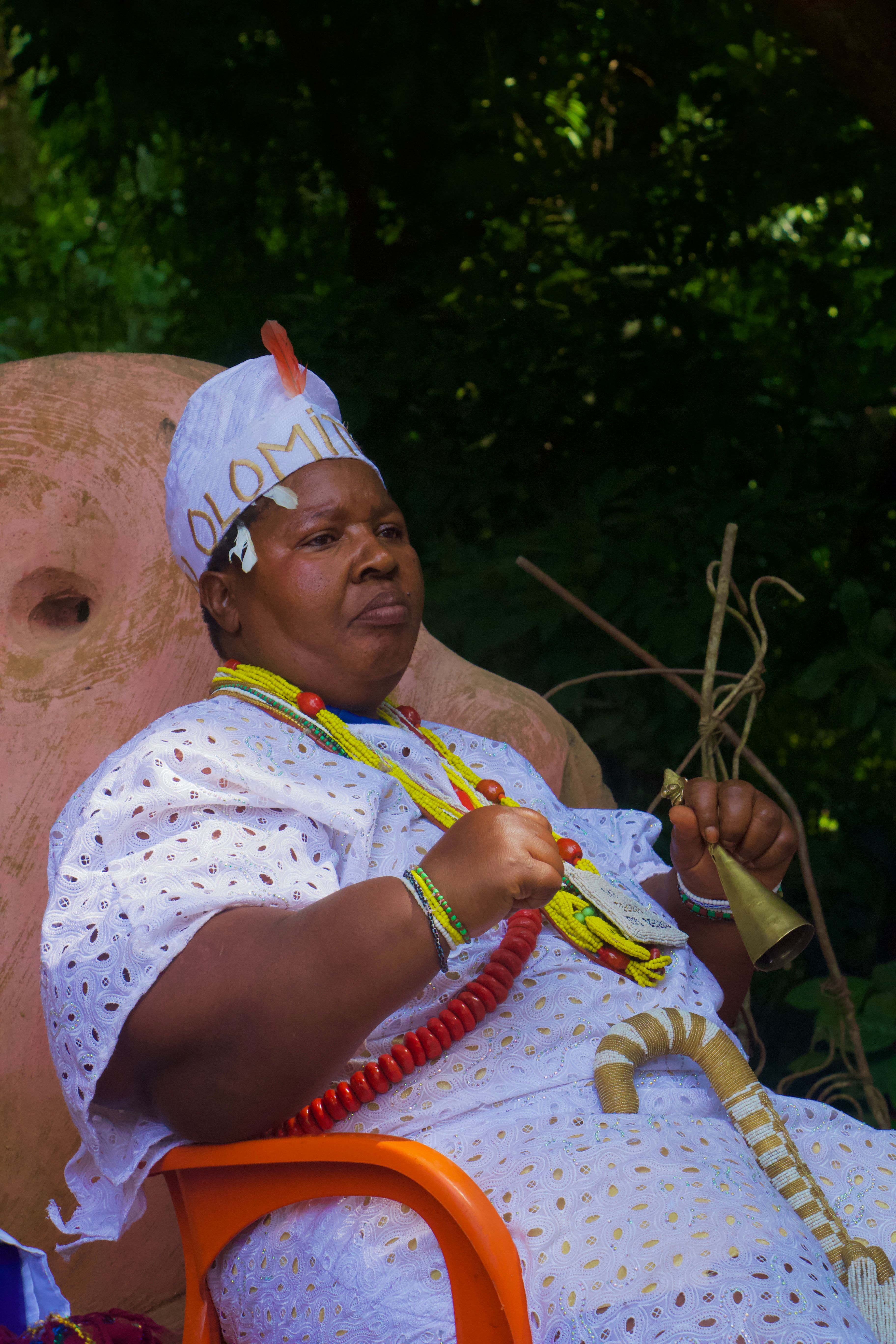Woman in traditional attire at a cultural festival, outdoors, showcasing heritage.