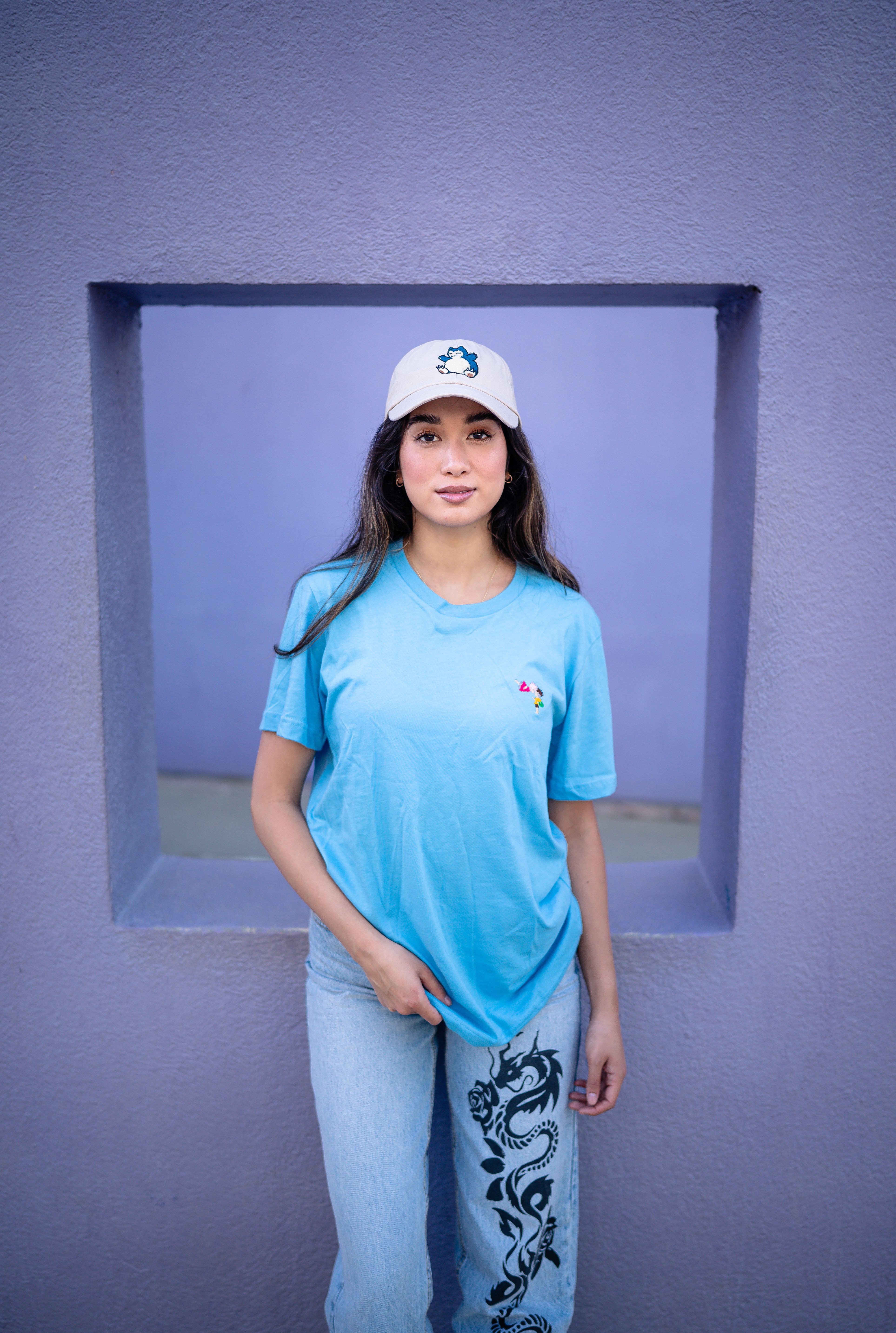 A girl in a blue shirt and jeans poses for a picture · Free Stock Photo