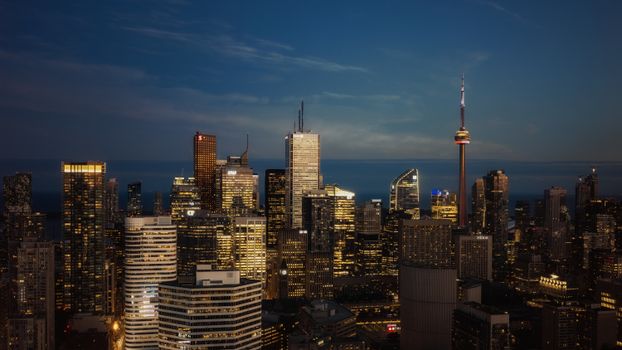 Panoramic view of Toronto's skyline featuring the iconic CN Tower at twilight.