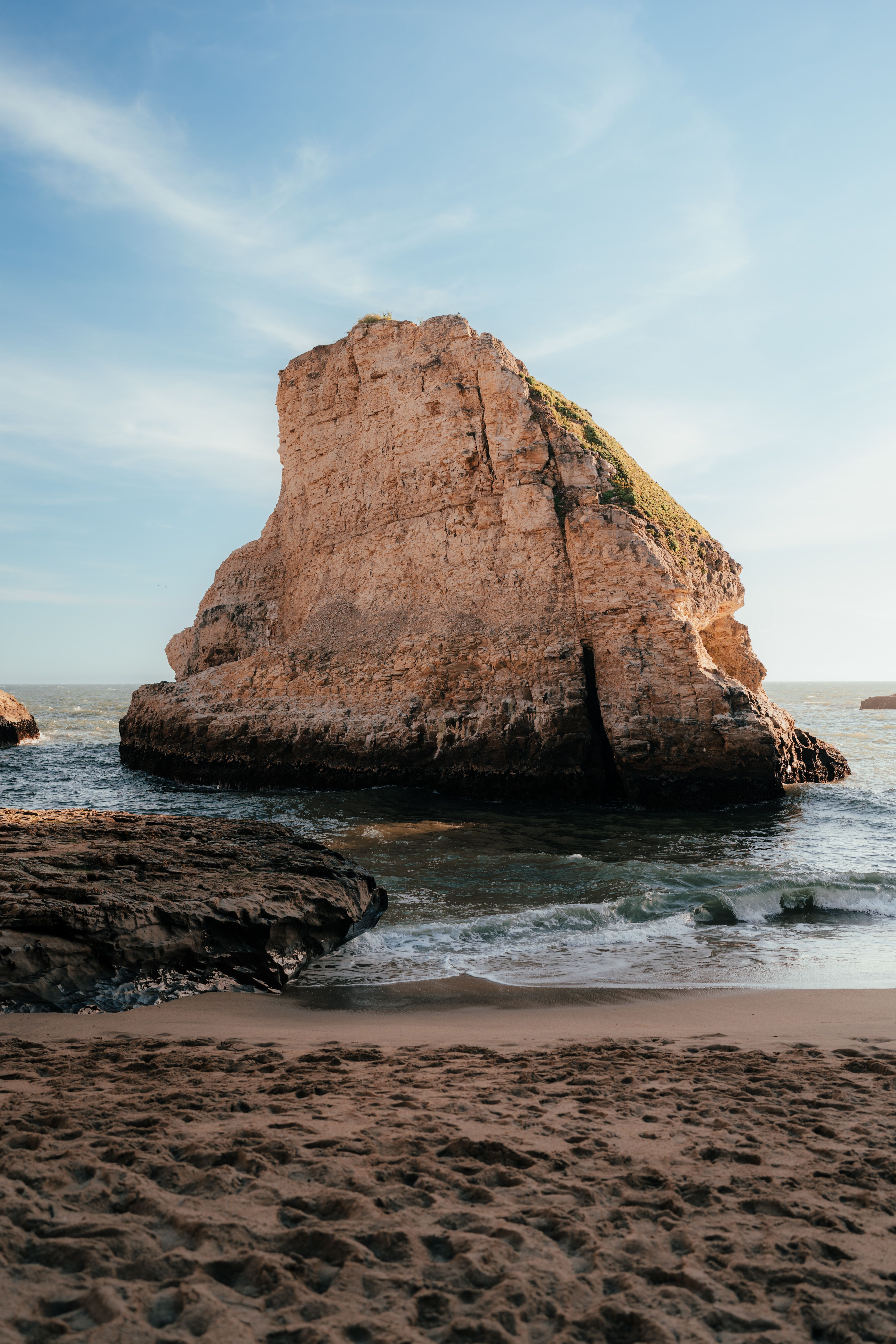 A rock formation on the beach near the ocean · Free Stock Photo