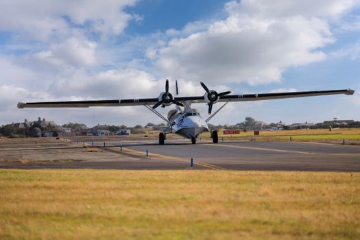 A vintage seaplane with dual propellers on a runway, showcasing aviation history.