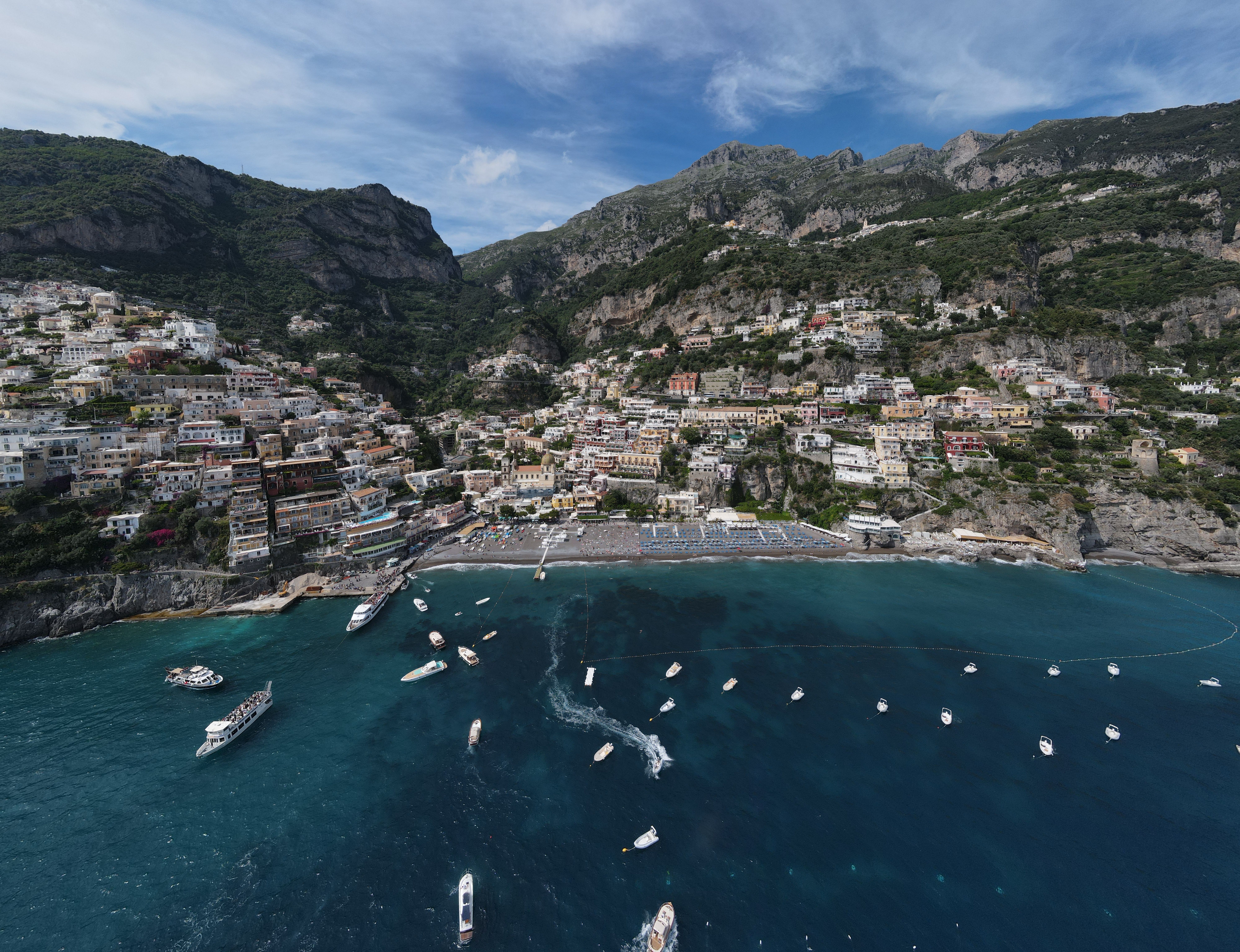 Spectacular aerial view of Positano, Italy with turquoise waters and hillside architecture.