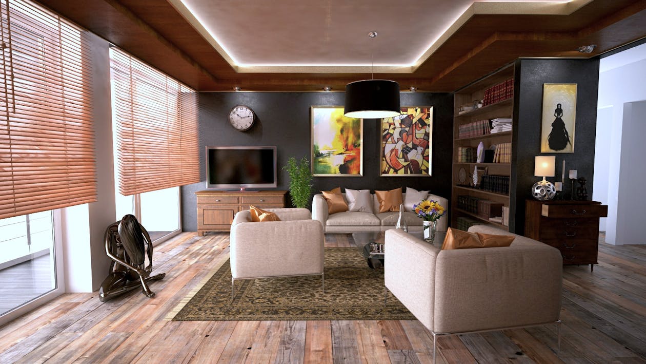 A room interior with a flat screen TV, wooden floors, and black walls.