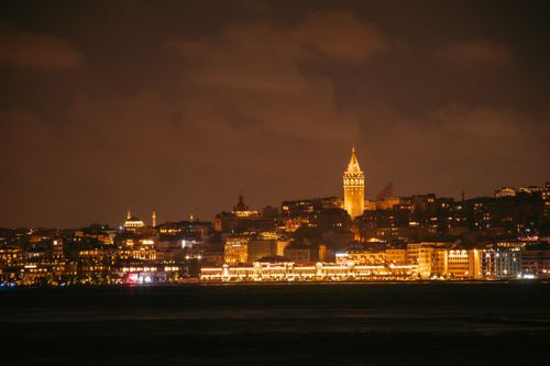 Free Stunning night skyline of Istanbul featuring the historic Galata Tower illuminated over the Bosphorus. Stock Photo