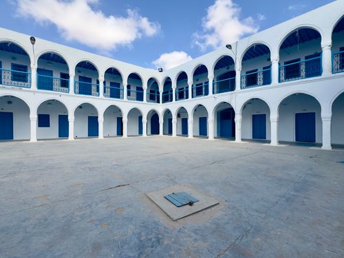 Free White and blue arched courtyard in Médenine Governorate, Tunisia, under a clear sky. Stock Photo