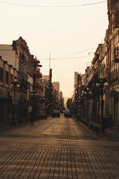 Serene street view with historic architecture at sunset, evoking classic urban charm.
