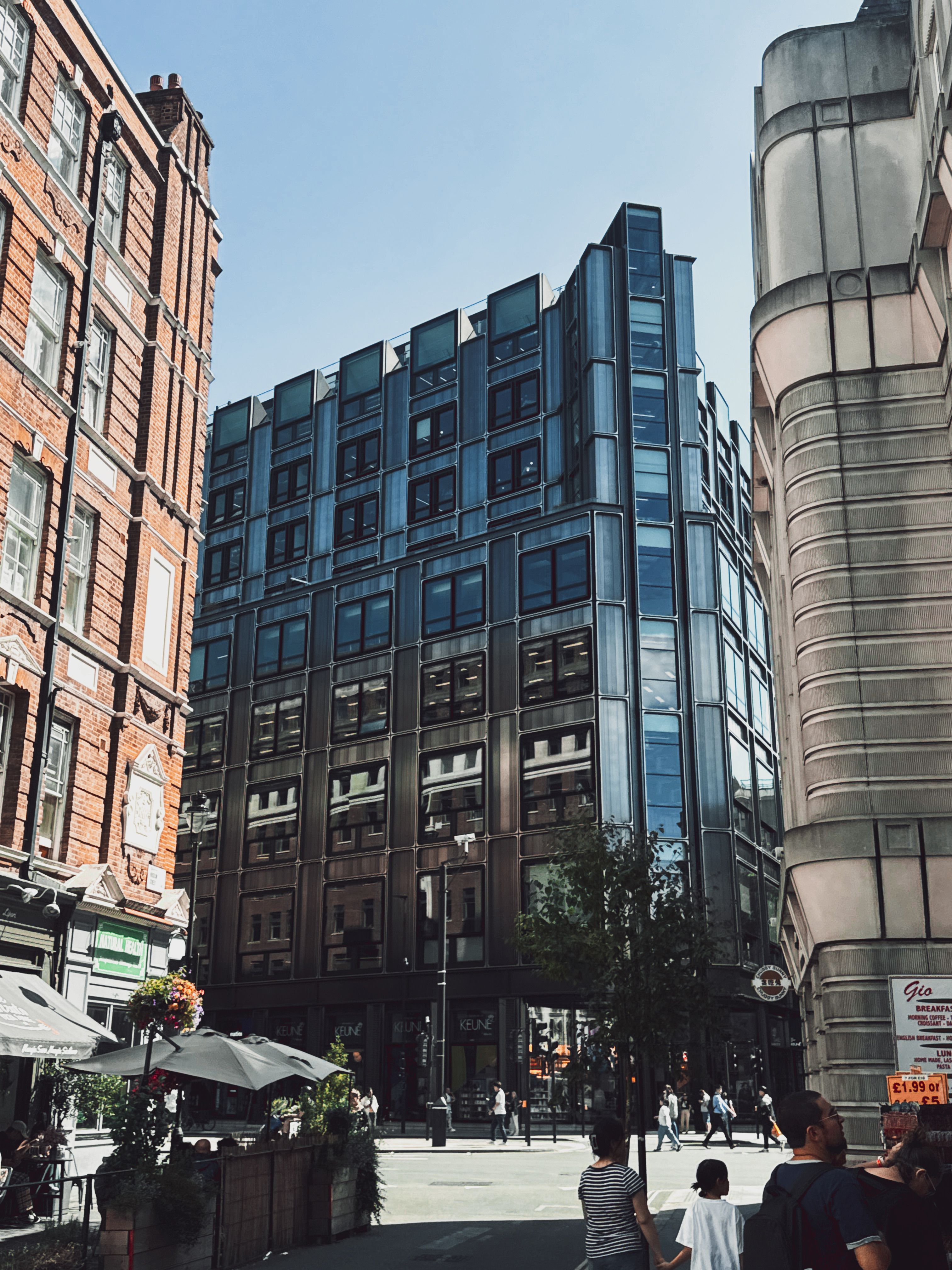 A city street with buildings and people walking · Free Stock Photo